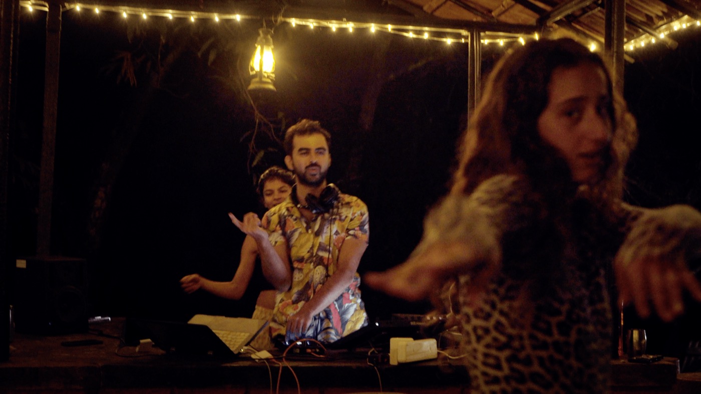 DJ and dancers at the outdoor dancefloor at night