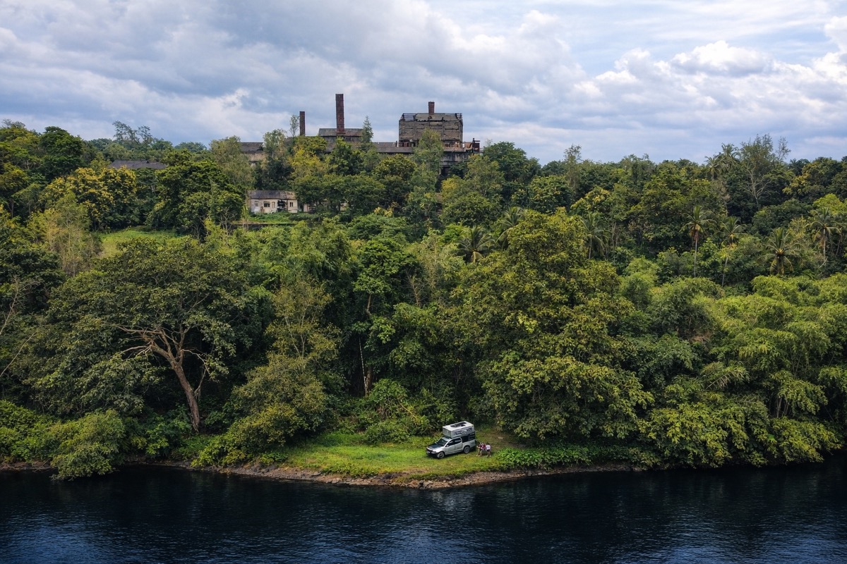 Vehicle parked deep in the Jungli forest with the historic factory ruins visible through the canopy