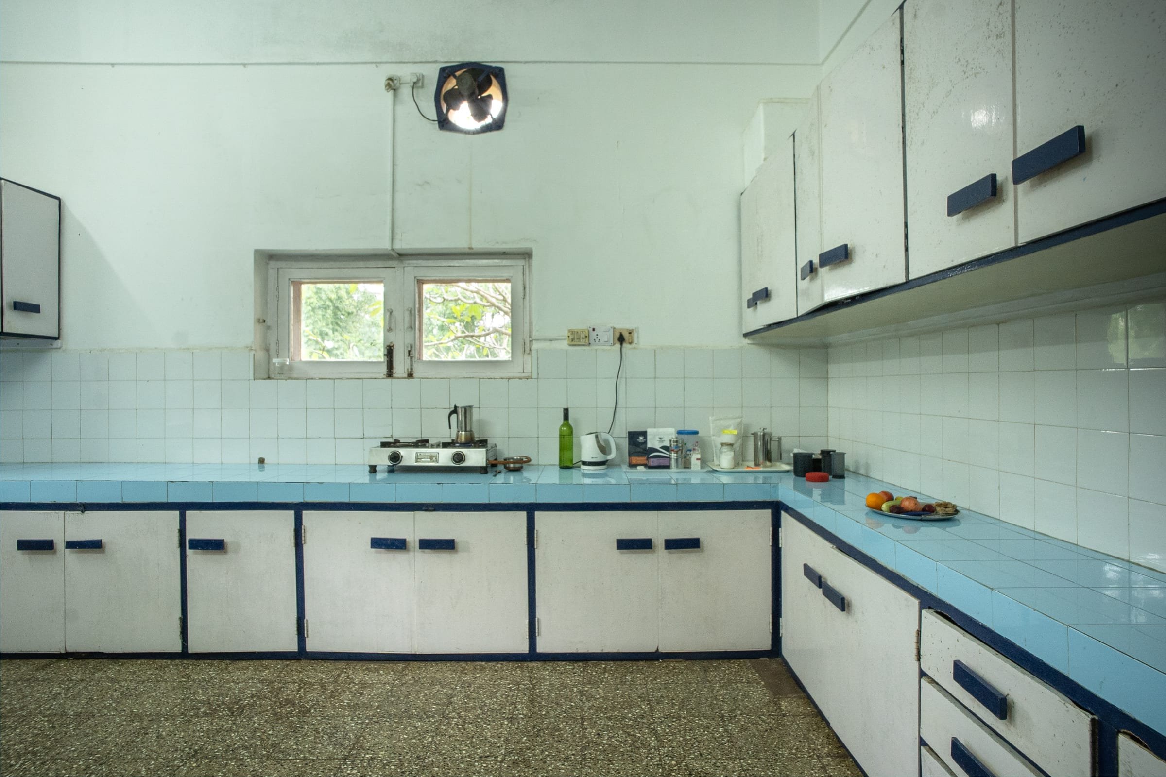 A bright, tiled community kitchen at Jungli