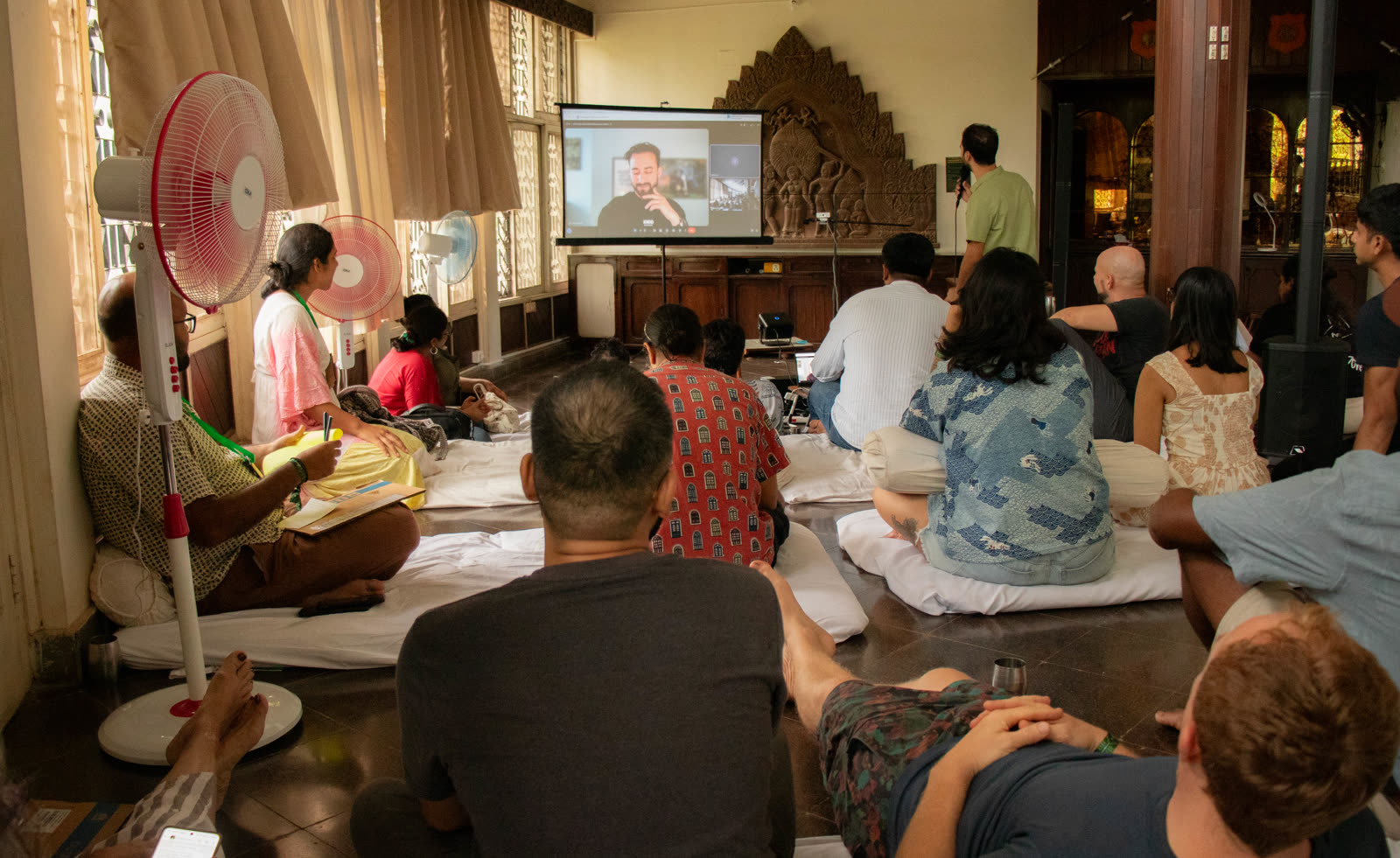 Attendees watching a video call talk at JTNF