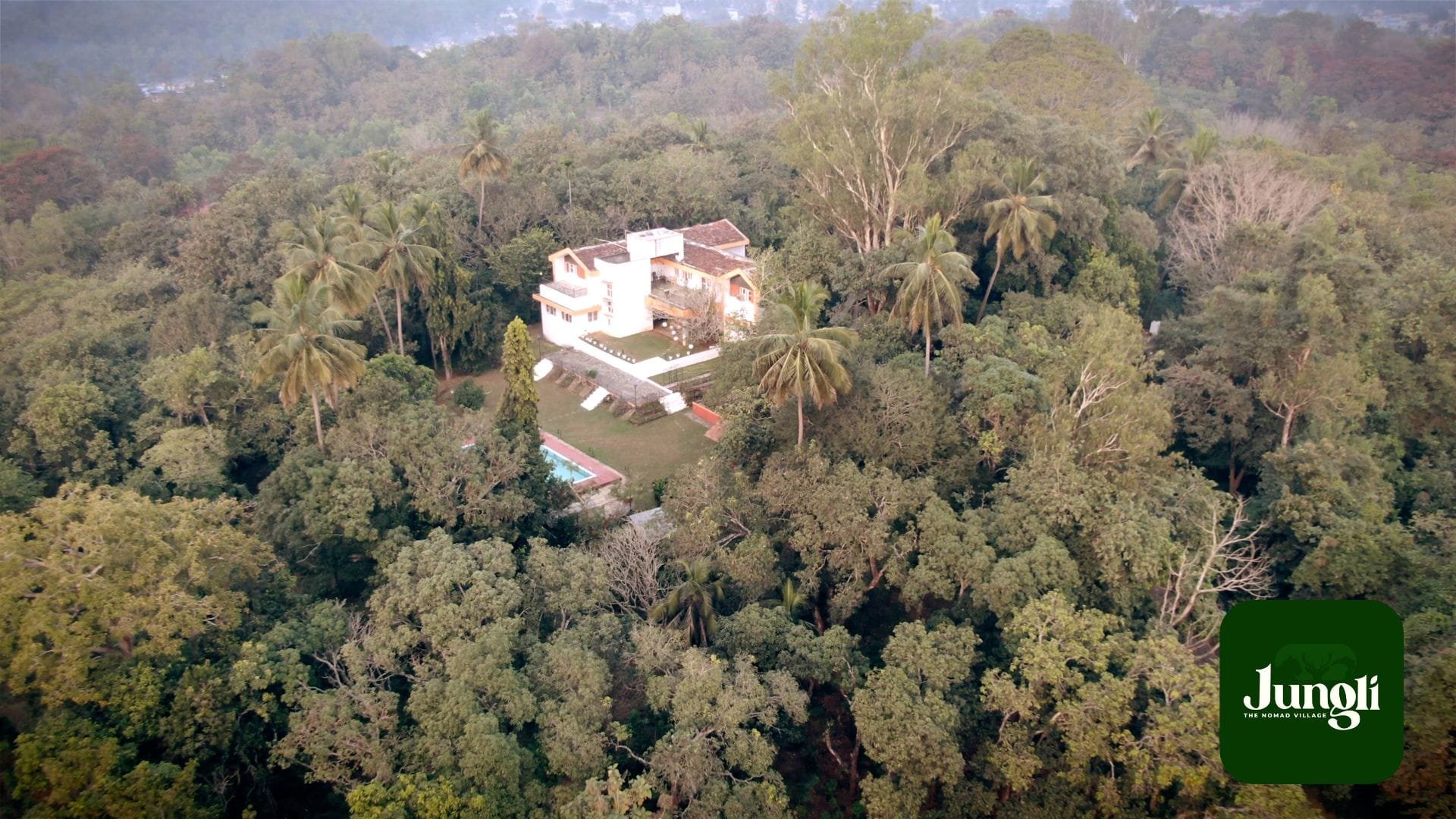 Aerial view of the Jungli campus nestled in dense green jungle